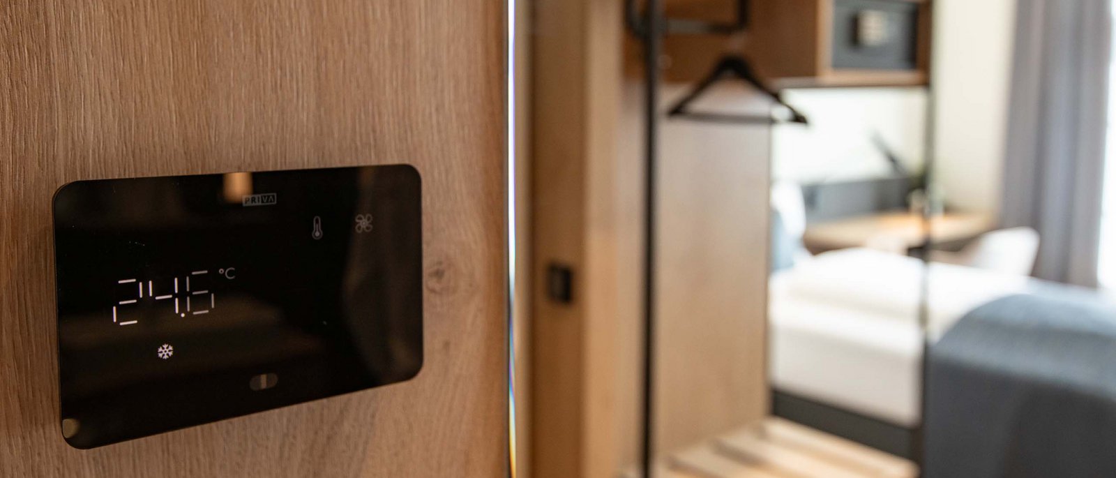 Single room Digital temperature display in a room next to a wardrobe