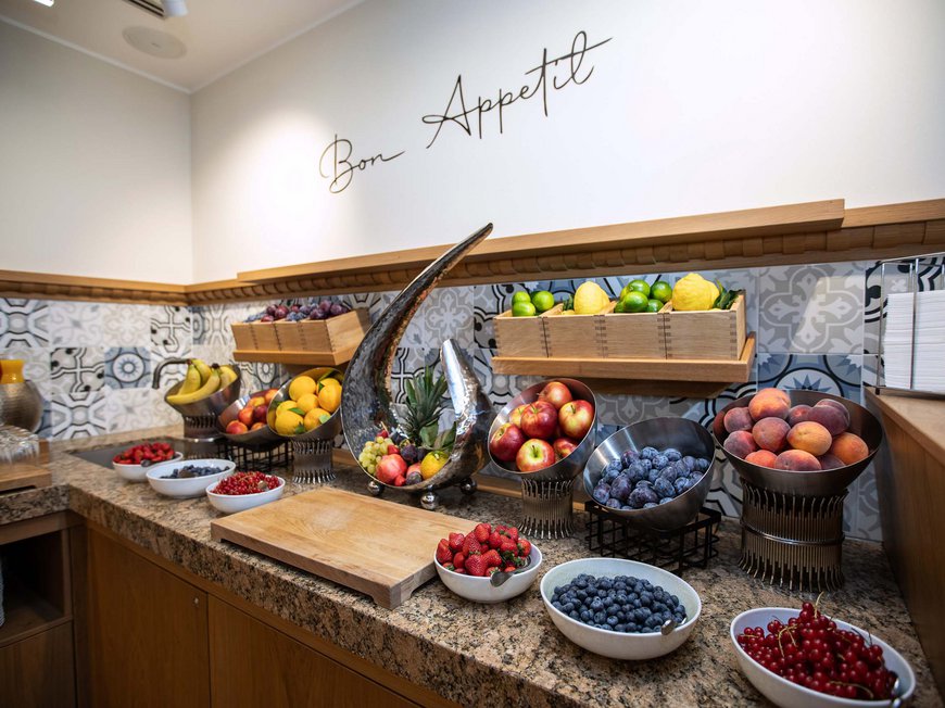 Cuisine at Hotel Böhlerstern Various fresh fruits on a buffet with Bon Appetit sign on the wall