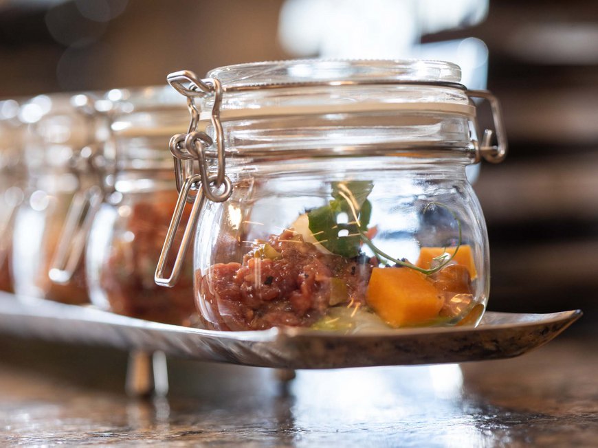 Cuisine at Hotel Böhlerstern Sealed glass jars with gourmet food and garnish on a tray