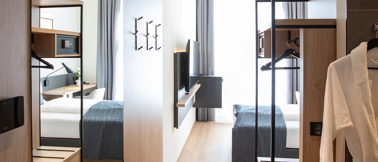 Single room Modern hotel room hallway with large mirror and open wardrobe area