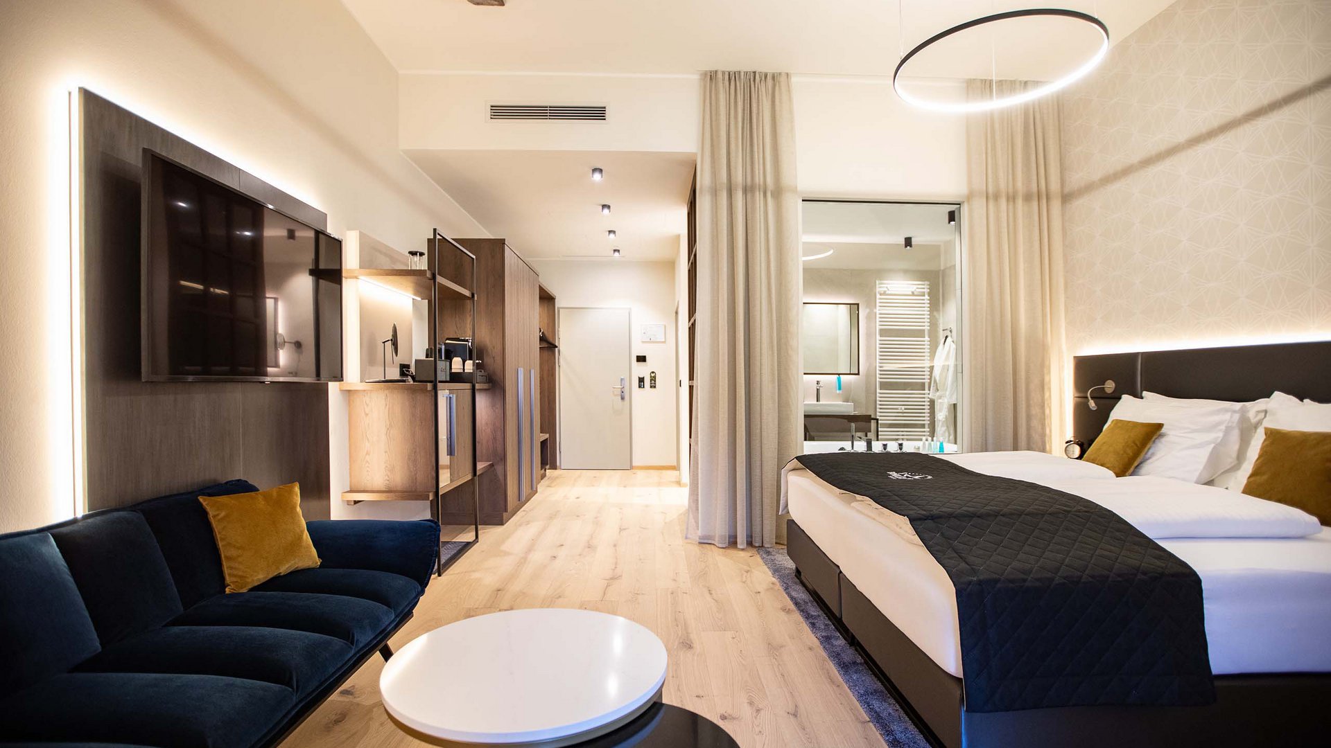 Böhlerstern: das Hotel in Kapfenberg für Seminare und Veranstaltungen Modernes Hotelzimmer mit Bett, Sofa, Fernseher und offenem Bad